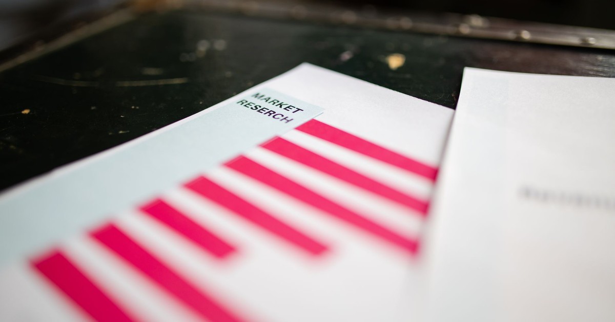 A detailed close-up of a market research document featuring a bar graph and a focus on market trends.