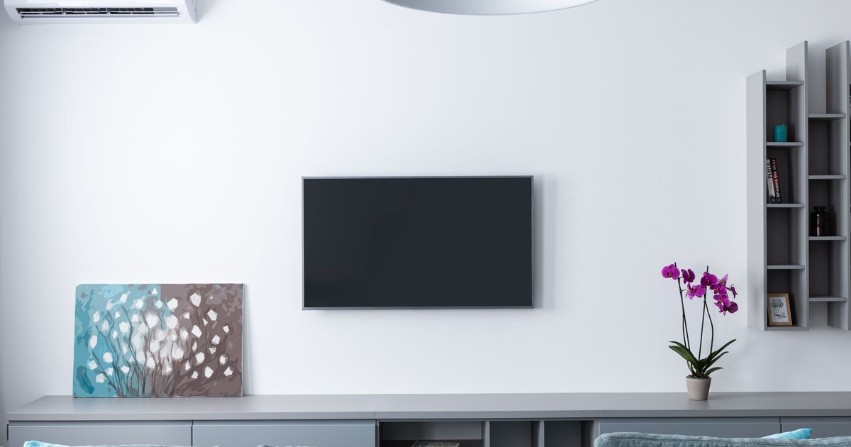 Contemporary living room decorated with purple flowers and rectangular shaped shelves handing on wall
