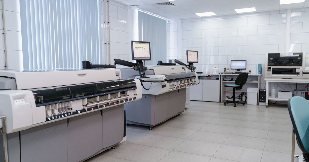 Spacious laboratory interior featuring state-of-the-art machines and computers for research purposes.