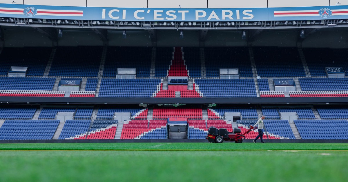 Gardener working on the field at Parc des Princes stadium, Paris. Vibrant and iconic sports venue.