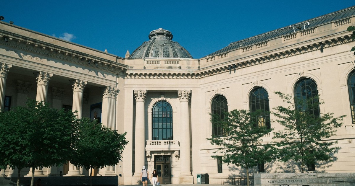 Elegant classical architecture of a historic library center under clear blue sky.