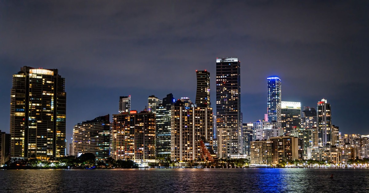 Captivating view of Miami's illuminated skyline at night, showcasing its modern architecture and vibrant city life.