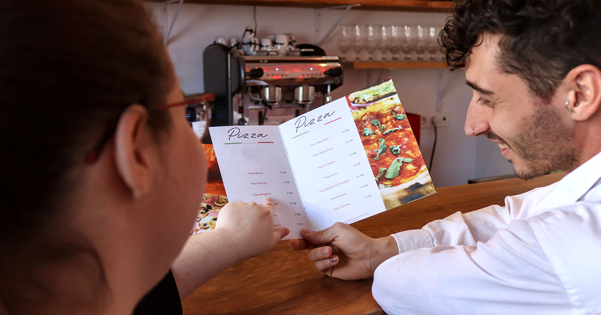 person smiling looking at menu