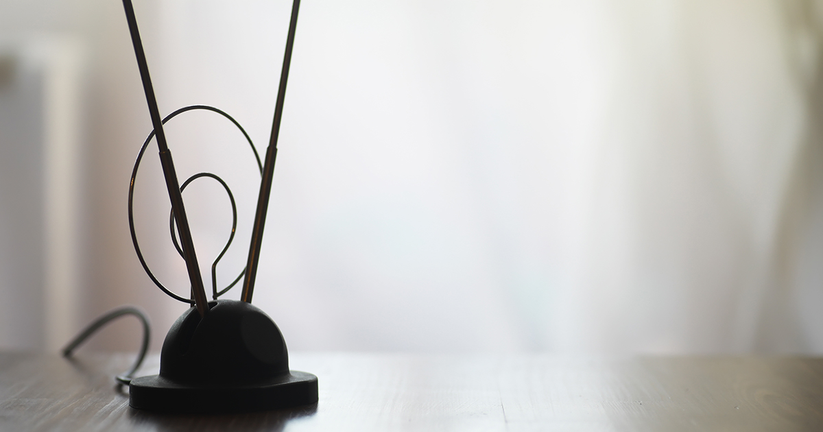 Vintage TV Antenna on Wooden Table in Soft Natural Light for Retro Technology Concept