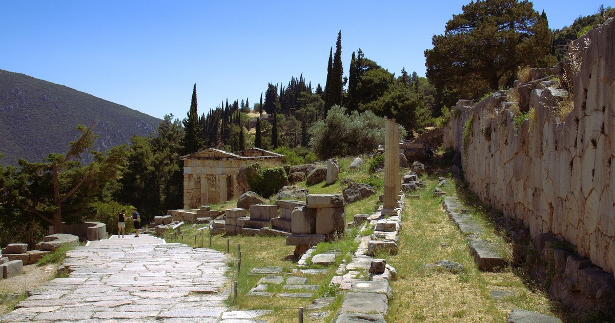 Explore the ancient ruins of Delphi, Greece, amidst a breathtaking natural landscape.