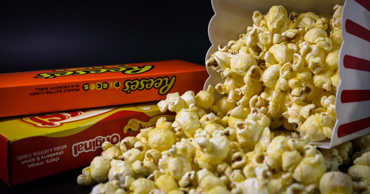 Close-up of spilled popcorn and candy boxes, perfect for snacks or movie night imagery.