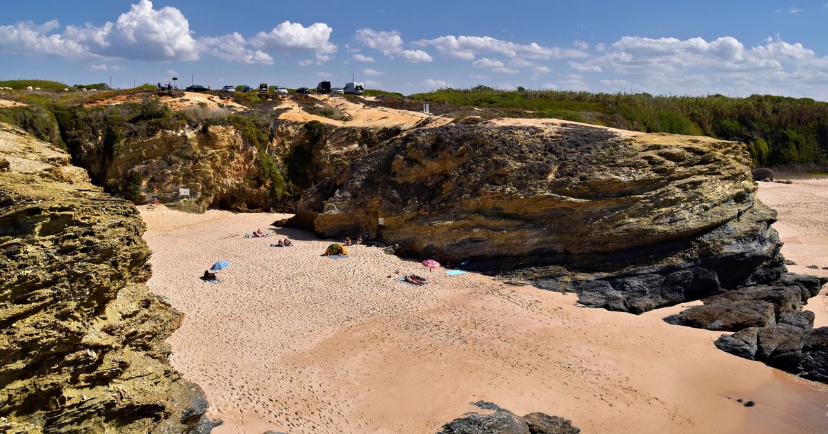Idyllic rocky beach with clear skies in Setubal, Portugal. Perfect summer getaway.