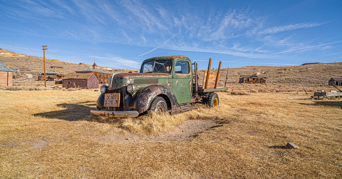 An old, rusty truck in Bodie Ghost Town under the clear blue sky.