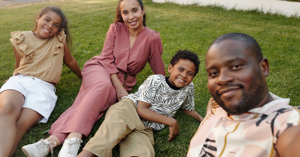 A joyful multiracial family enjoying time together in a sunny garden.
