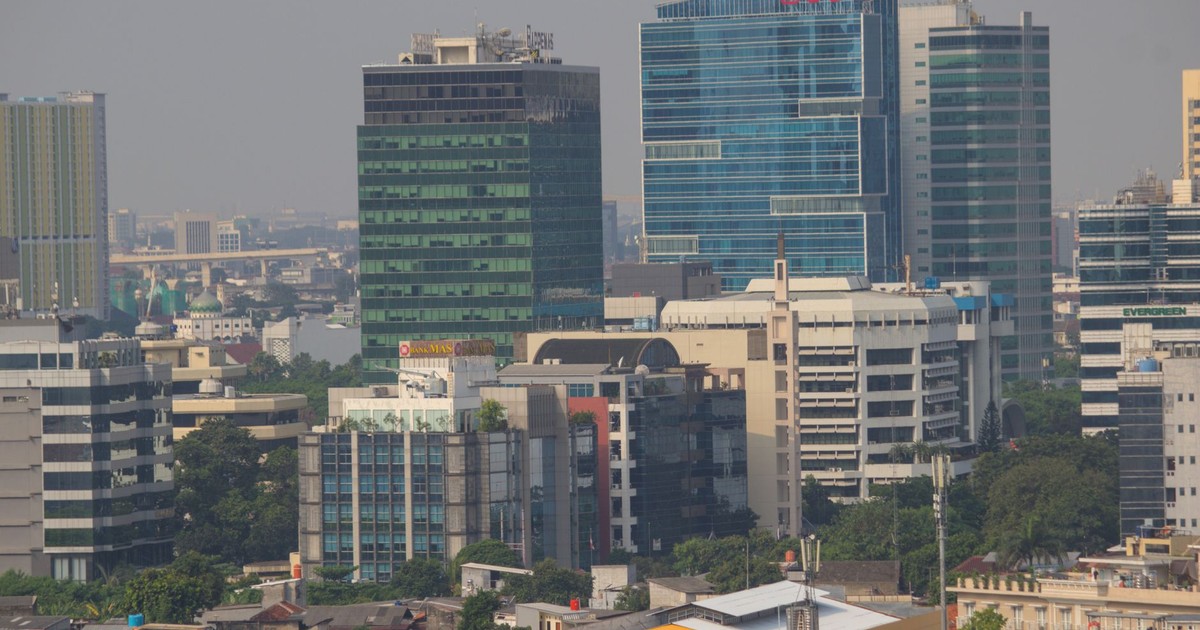 Aerial view of Jakarta's urban skyline showcasing modern skyscrapers and bustling city life.