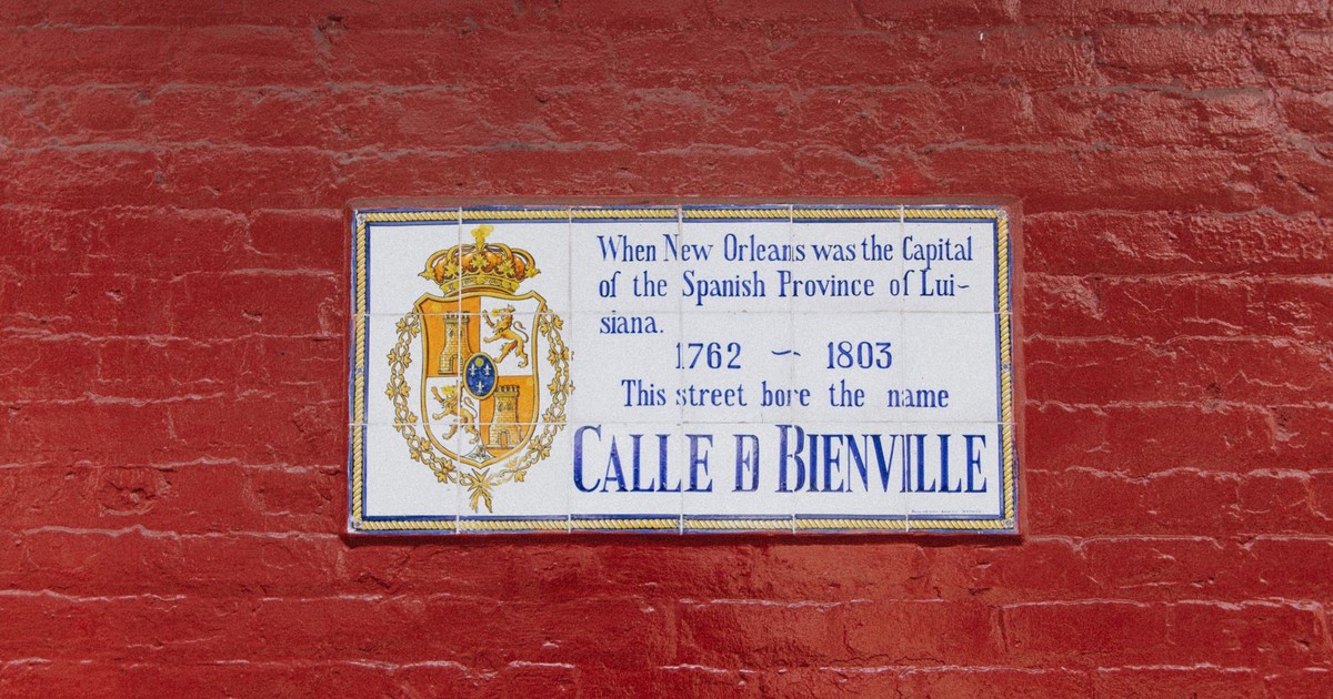 Street sign on a red brick wall, New Orleans, Spanish era history.