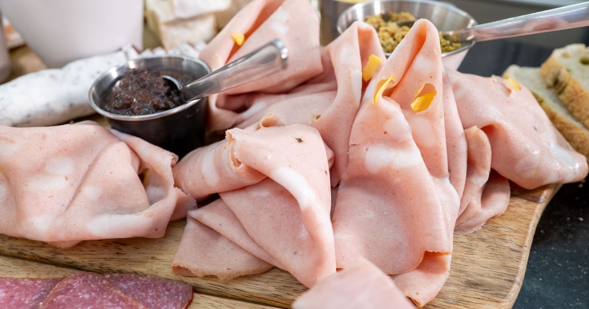 A delicious charcuterie board featuring mortadella and an assortment of sauces perfect for a gourmet snack.