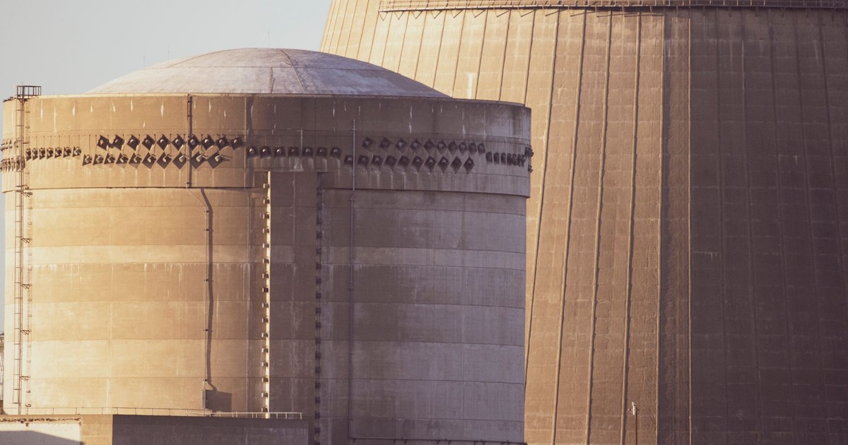 Close-up view of nuclear reactor buildings bathed in golden light, showcasing industrial architecture.