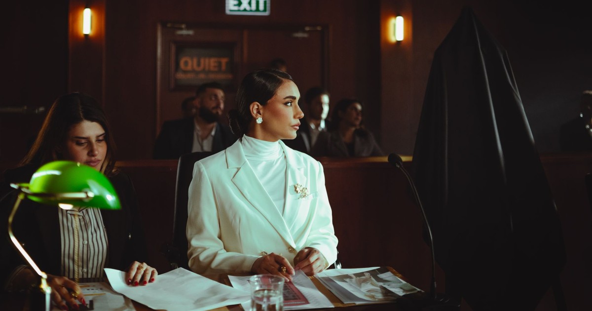 A businesswoman attentively listening in a courtroom environment, Baghdad, Iraq.