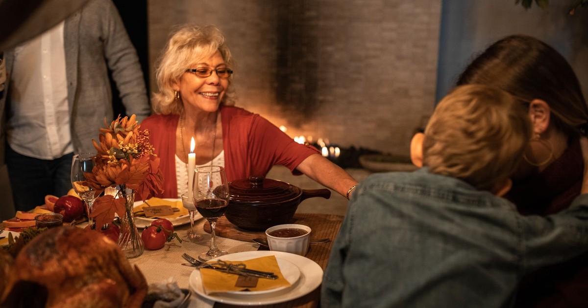 Joyful family celebration around the Thanksgiving dinner table with delicious food and warm atmosphere.