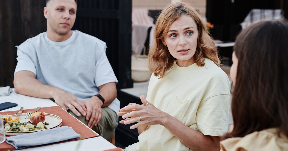 A group of adults enjoying a relaxed outdoor meal together.