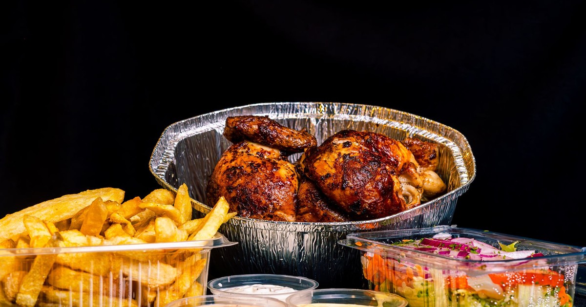 Appetizing rotisserie chicken with french fries and salad, a perfect meal.