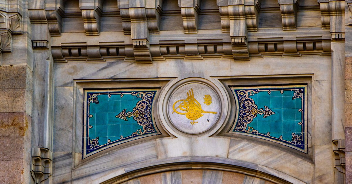 Detailed view of an ornate facade showcasing intricate Islamic architectural elements and designs.