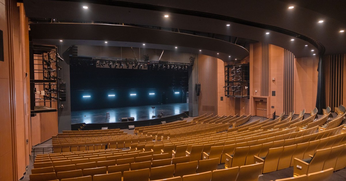 Spacious empty theatre auditorium with wooden seating in Varanasi, India.