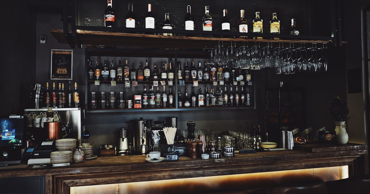 A stylish bar interior showcasing a variety of spirits and glasses.