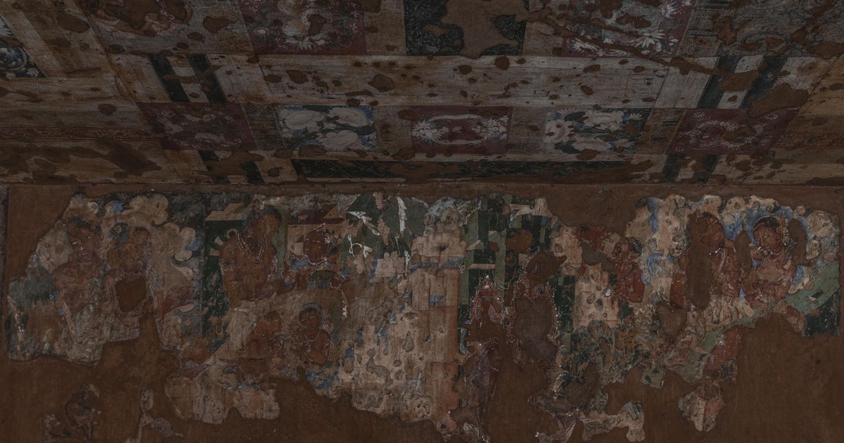 Detailed view of ancient frescoes in Ajanta Caves depicting Buddhist art.