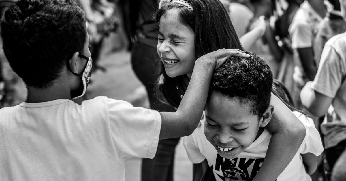 Happy children enjoying playful moments outdoors in Cali, Colombia.