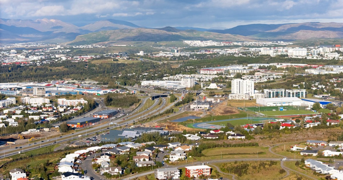 Stunning aerial view of Reykjavík, Iceland, showcasing urban architecture and surrounding mountains.