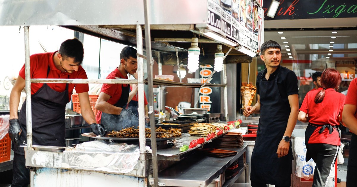 Street food vendors in an urban setting preparing a variety of meals. Perfect for food and urban culture themes.