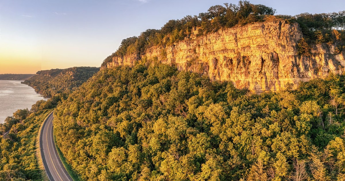 Breathtaking aerial view of a winding road along a cliff with lush greenery, near Stockholm, Wisconsin.