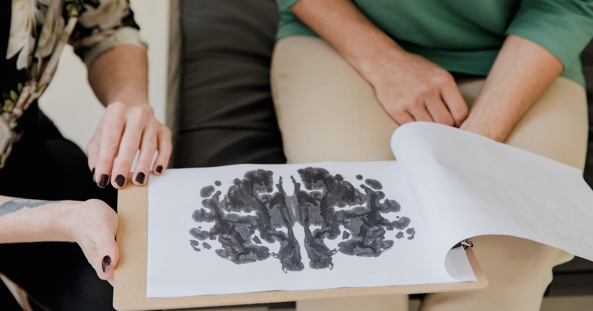 A close-up of a Rorschach inkblot test during a psychotherapy session, highlighting mental health care.