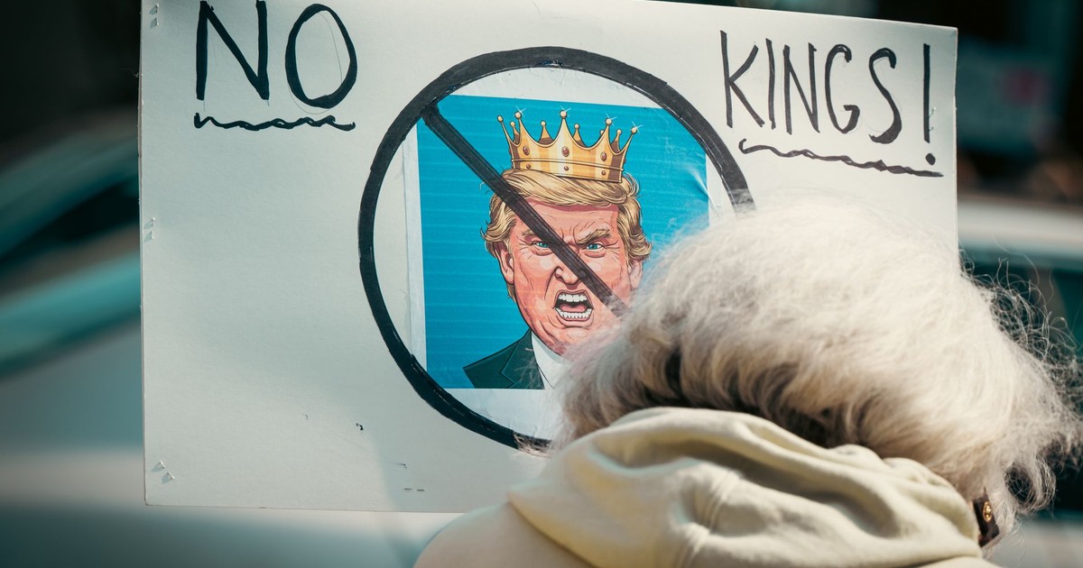 A protest sign reading 'No Kings' depicts resistance against monarchy with a satirical image.
