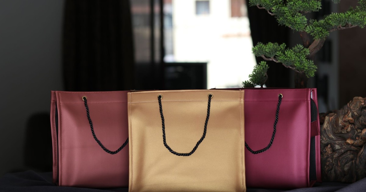 Luxurious leather shopping bags in rich colors elegantly arranged indoors.